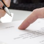 Woman signing a paper